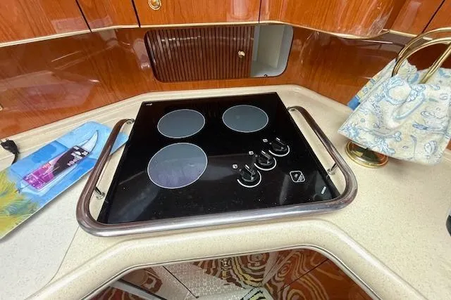 Slide: The Image of Modern kitchen area in a 2001 Sea Ray 420 Aft Cabin yacht with electric stovetop. - 40