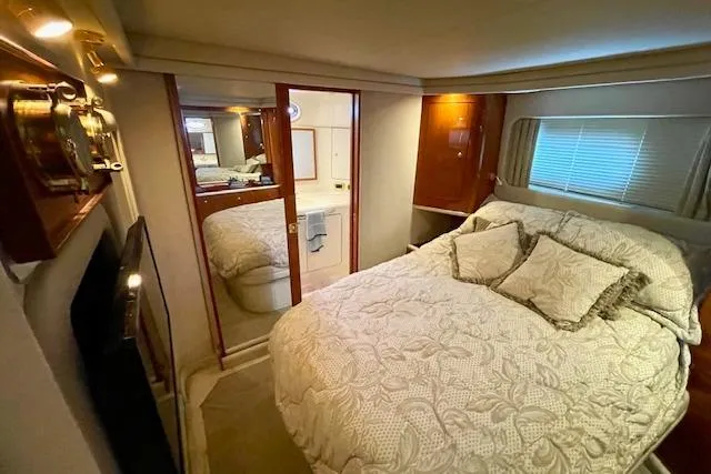 Slide: The Image of Luxurious bedroom interior of 2001 Sea Ray 420 Aft Cabin yacht with elegant bedding. - 43