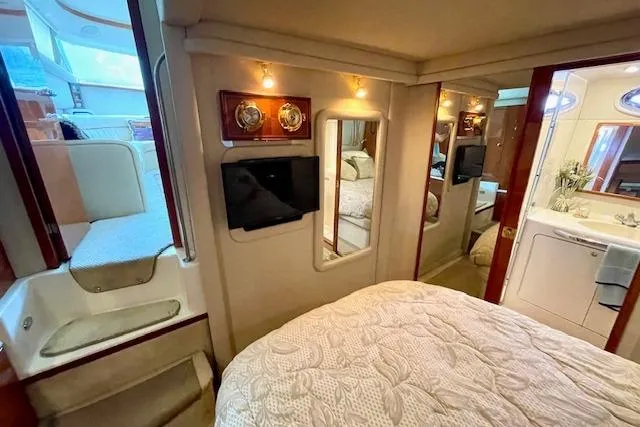 Slide: The Image of Luxurious interior of 2001 Sea Ray 420 Aft Cabin yacht with cozy bedroom and modern amenities. - 45