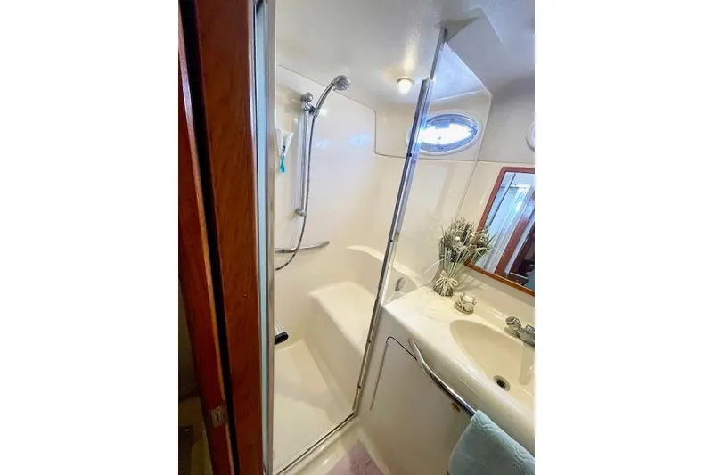 Slide: The Image of Bathroom interior of 2001 Sea Ray 420 Aft Cabin yacht, featuring shower and sink. - 46