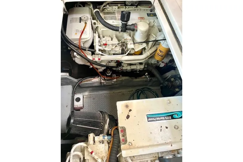 Slide: The Image of Engine compartment of a 2001 Sea Ray 420 Aft Cabin boat, showcasing mechanical components. - 51