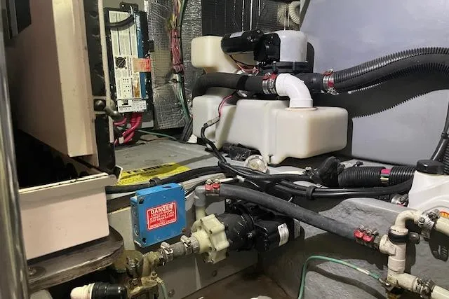 Slide: The Image of Engine room of 2001 Sea Ray 420 Aft Cabin with various mechanical components and wiring. - 56