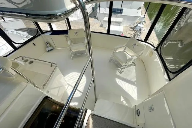 Slide: The Image of 2001 Sea Ray 420 Aft Cabin interior with seating and windows, showcasing spacious design. - 7