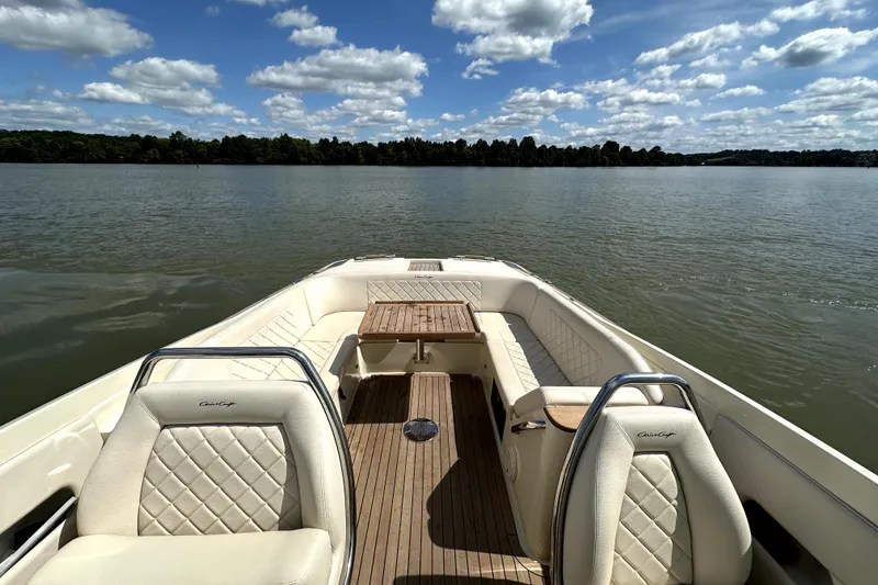Slide: The Image of 2019 Chris-Craft Launch 30 boat interior with elegant seating on a serene lake. - 10