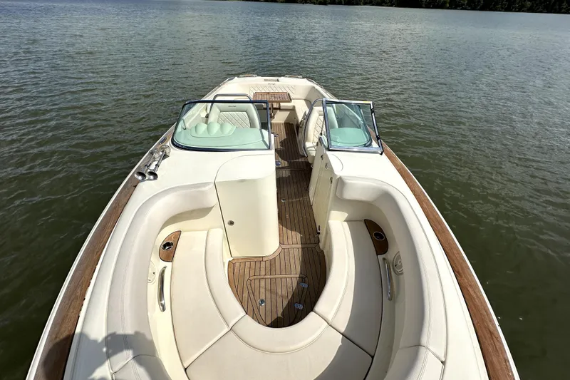 Slide: The Image of 2019 Chris-Craft Launch 30 boat with elegant seating and wooden deck on calm water. - 13