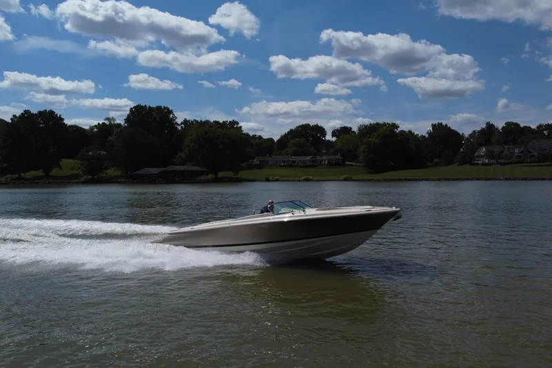 Slide: The Image of 2019 Chris-Craft Launch 30 speeding on a lake under a partly cloudy sky. - 3