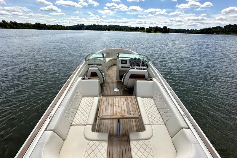 Slide: The Image of 2019 Chris-Craft Launch 30 boat on a serene lake with clear skies. - 8