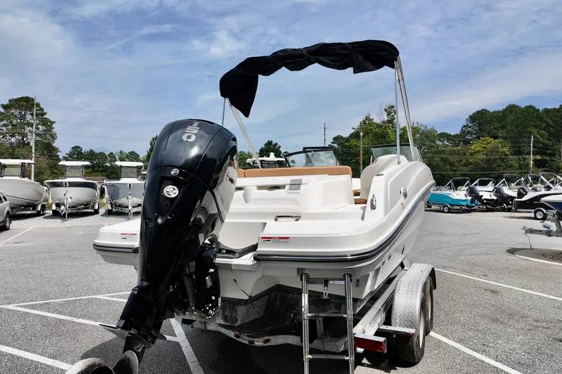 Slide: The Image of 2021 Bayliner VR5 Bowrider OB on trailer, featuring outboard motor and canopy. - 1