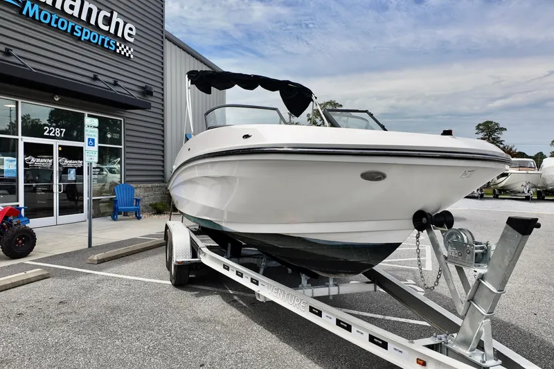 Slide: The Image of 2021 Bayliner VR5 Bowrider OB on trailer outside dealership, ready for adventure. - 2