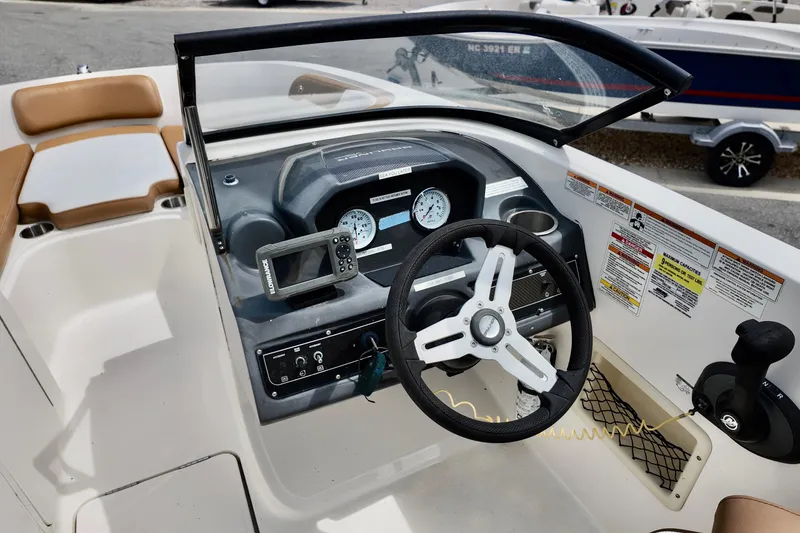 Slide: The Image of 2021 Bayliner VR5 Bowrider OB dashboard with steering wheel and control panel. - 4