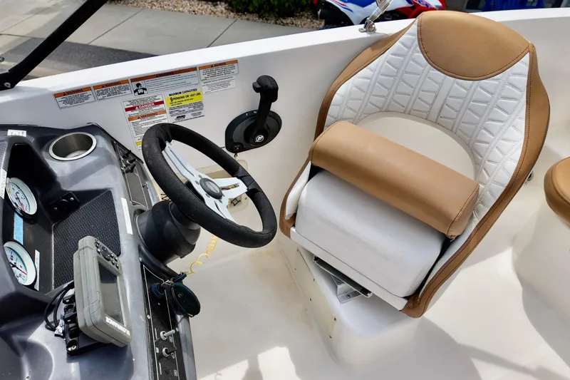 Slide: The Image of 2021 Bayliner VR5 Bowrider OB cockpit with steering wheel and cushioned seat. - 5