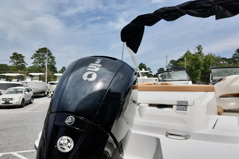 Slide: The Image of 2021 Bayliner VR5 Bowrider OB with powerful outboard motor in a marina setting. - 9