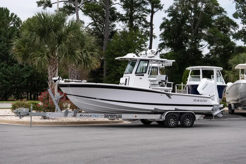 The Image of 2026 Blackfin 262 HB boat on trailer, parked near palm trees. - 1