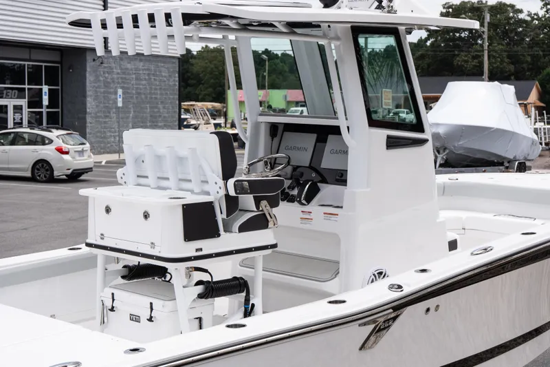 Slide: The Image of 2026 Blackfin 262 HB boat with modern console and seating, parked outdoors. - 10
