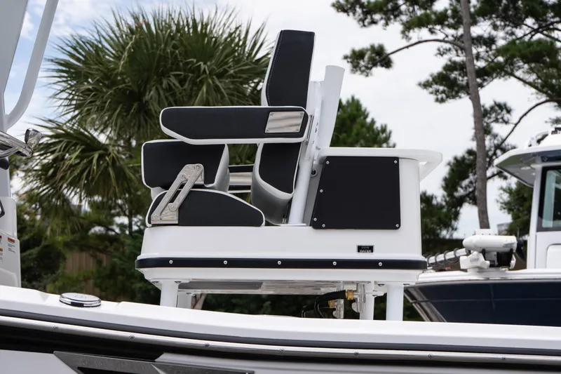 Slide: The Image of 2026 Blackfin 262 HB boat seat with sleek design, surrounded by trees. - 12