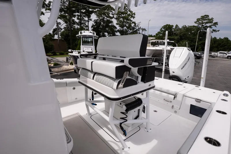 Slide: The Image of 2026 Blackfin 262 HB boat interior with seating and Mercury engine in a marina setting. - 26