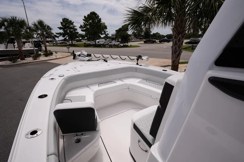 Slide: The Image of 2026 Blackfin 262 HB boat with spacious seating, docked near palm trees. - 29
