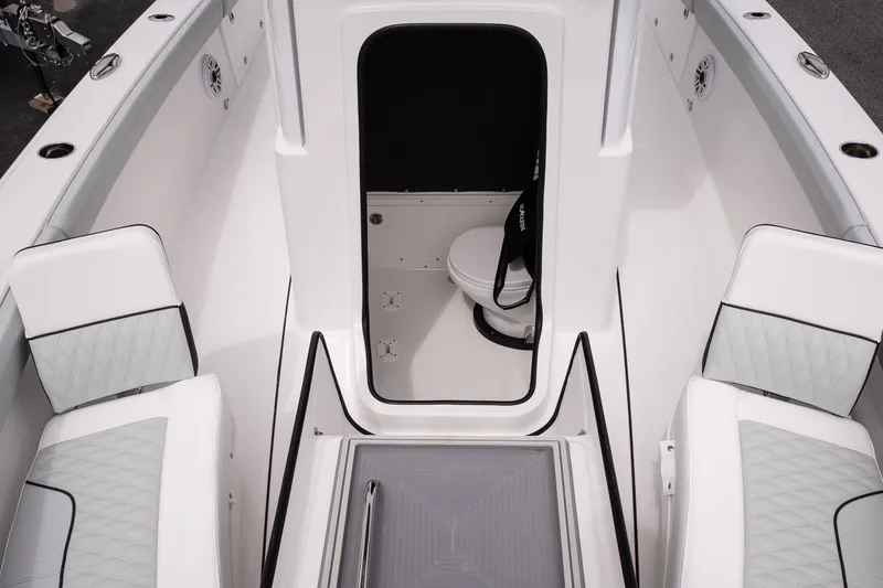 Slide: The Image of 2026 Blackfin 262 HB boat interior with seating and compact toilet area. - 35