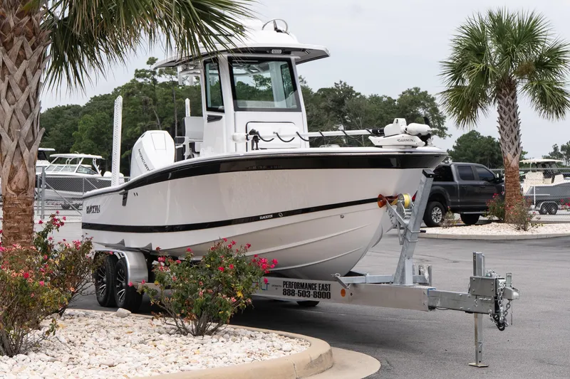 Slide: The Image of 2026 Blackfin 262 HB boat on trailer, surrounded by palm trees and flowers. - 5