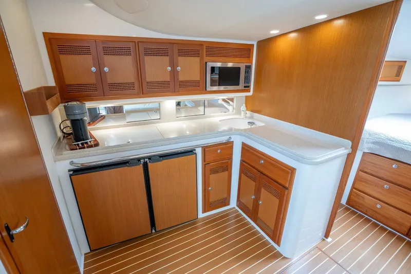 Slide: The Image of Luxurious 2004 Cabo 40 Express yacht interior with modern kitchen amenities. - 10