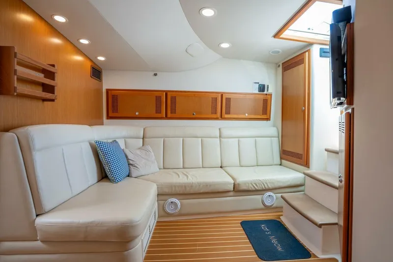 Slide: The Image of Luxurious interior of 2004 Cabo 40 Express yacht with cream leather seating and wooden accents. - 11
