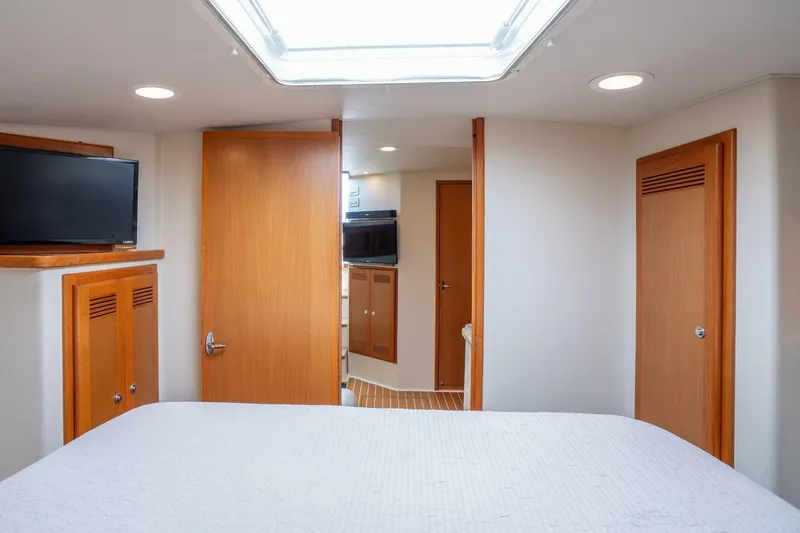 Slide: The Image of Interior of 2004 Cabo 40 Express yacht with wood accents and modern amenities. - 12