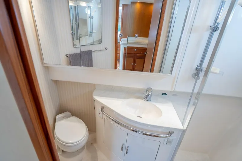 Slide: The Image of Luxurious bathroom in 2004 Cabo 40 Express yacht with modern fixtures and elegant design. - 13