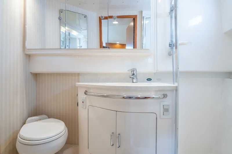 Slide: The Image of Luxurious bathroom in 2004 Cabo 40 Express yacht with modern fixtures and elegant design. - 14