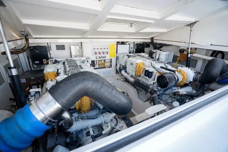 Slide: The Image of Engine room of 2004 Cabo 40 Express yacht, showcasing dual engines and mechanical systems. - 15