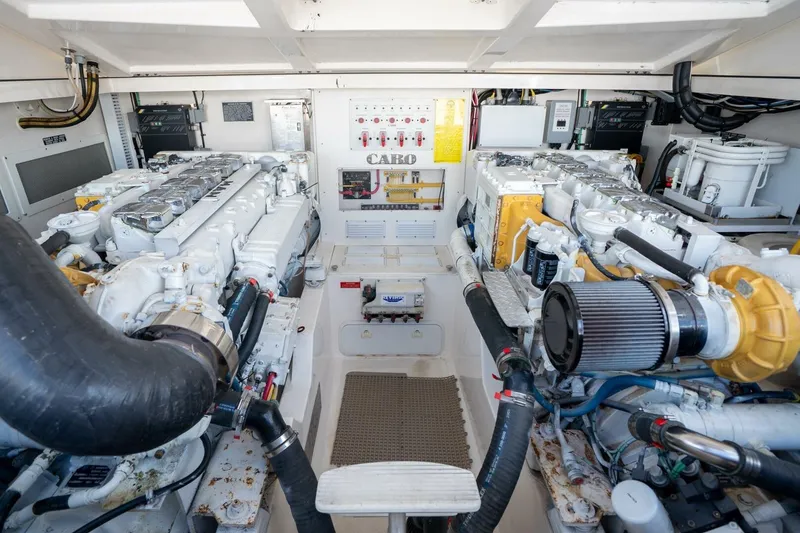 Slide: The Image of Engine room of a 2004 Cabo 40 Express yacht, showcasing dual engines and mechanical systems. - 16