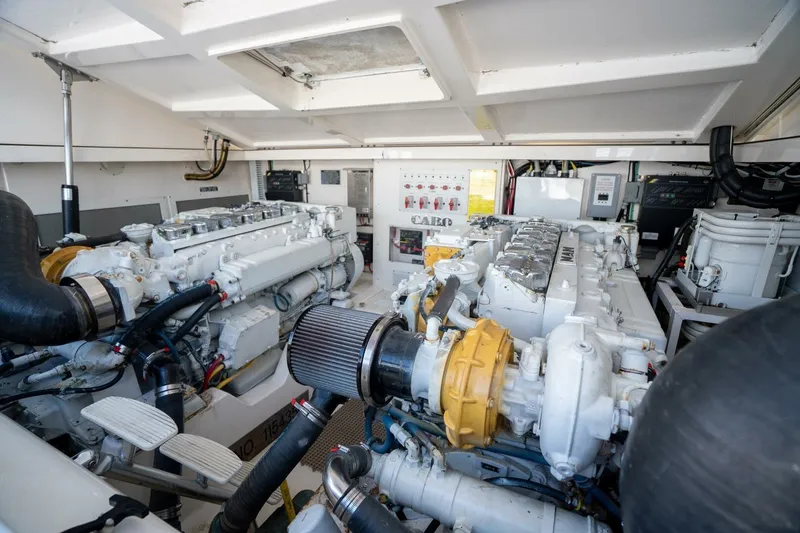 Slide: The Image of Engine room of a 2004 Cabo 40 Express boat, showcasing dual engines and mechanical components. - 17
