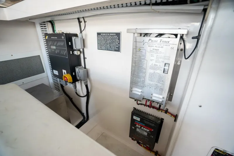 Slide: The Image of Electrical panel inside 2004 Cabo 40 Express boat, featuring various components and wiring. - 19