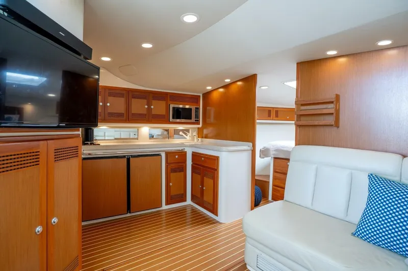 Slide: The Image of Luxurious interior of 2004 Cabo 40 Express yacht with modern kitchen and cozy seating. - 2