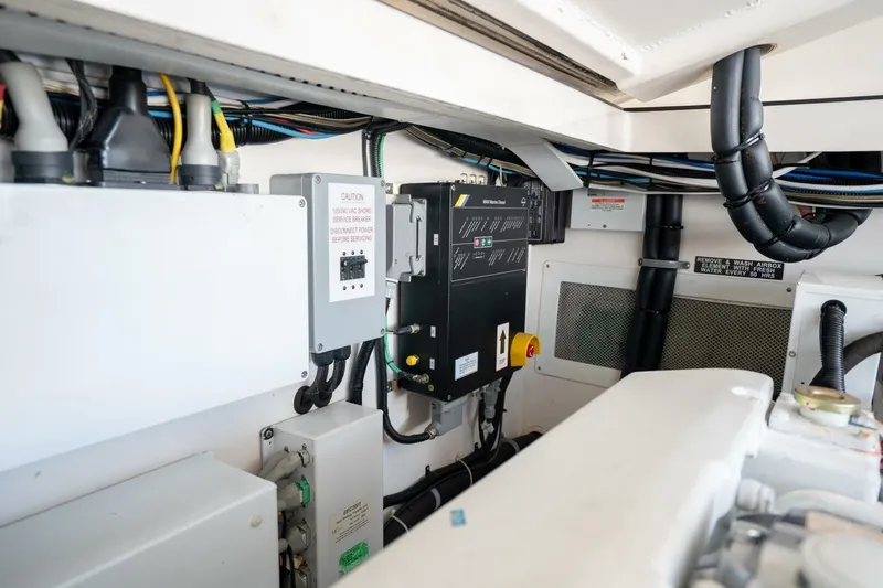Slide: The Image of Engine room of 2004 Cabo 40 Express boat, showcasing electrical systems and wiring. - 20