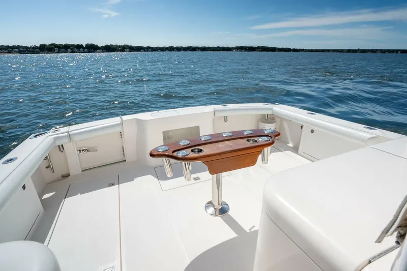 Slide: The Image of 2004 Cabo 40 Express boat deck with ocean view and fishing rod holders. - 21