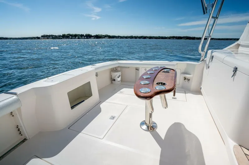 Slide: The Image of 2004 Cabo 40 Express boat deck with ocean view and fishing rod holders. - 24