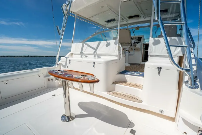 Slide: The Image of 2004 Cabo 40 Express yacht interior with seating, table, and ocean view. - 25