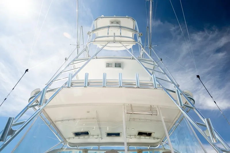 Slide: The Image of 2004 Cabo 40 Express yacht tower against a bright blue sky. - 26