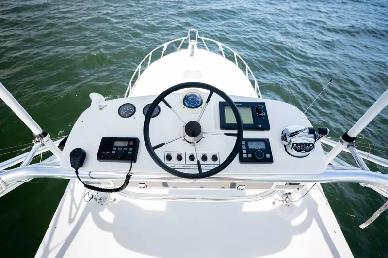 Slide: The Image of Helm of 2004 Cabo 40 Express boat with steering wheel and navigation controls. - 28