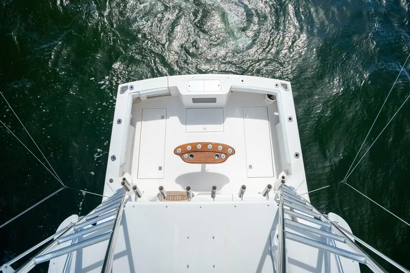 Slide: The Image of Aerial view of 2004 Cabo 40 Express boat deck on water. - 29
