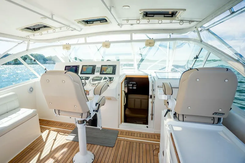 Slide: The Image of 2004 Cabo 40 Express yacht cockpit with navigation equipment and ocean view. - 31