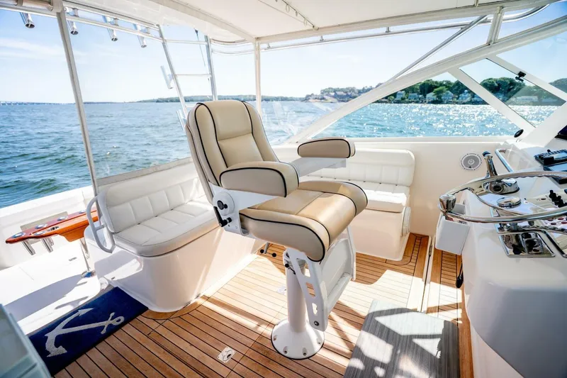 Slide: The Image of Luxurious 2004 Cabo 40 Express yacht interior with captain's chair and ocean view. - 34