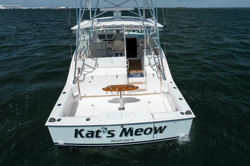 Slide: The Image of 2004 Cabo 40 Express boat named "Kat's Meow" on open water. - 4