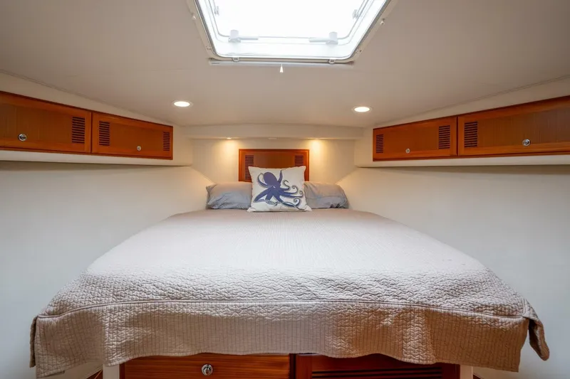 Slide: The Image of Cozy cabin interior of 2004 Cabo 40 Express yacht with bed and storage cabinets. - 9