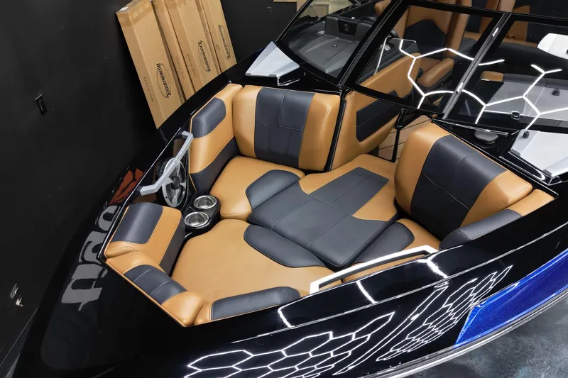 Slide: The Image of 2021 Malibu Wakesetter 20 VTX boat interior with tan and black seating. - 10