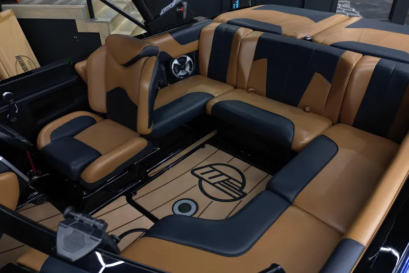 Slide: The Image of 2021 Malibu Wakesetter 20 VTX interior with tan and black seating, stylish and spacious design. - 11