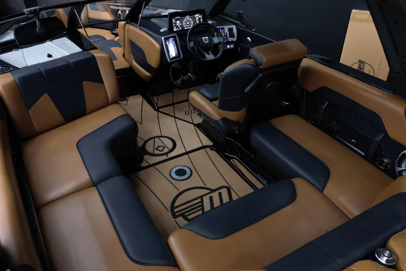 Slide: The Image of 2021 Malibu Wakesetter 20 VTX interior with luxurious brown and black seating, modern dashboard. - 12
