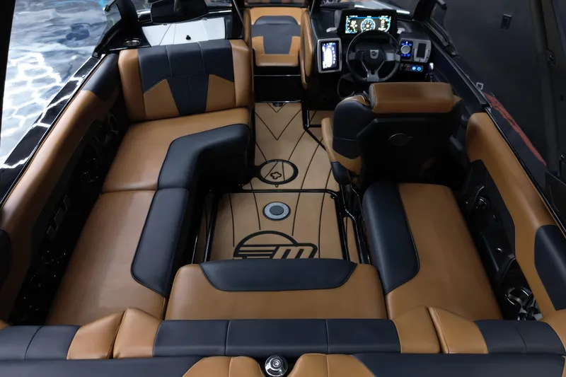 Slide: The Image of 2021 Malibu Wakesetter 20 VTX interior with luxurious tan and black seating. - 15