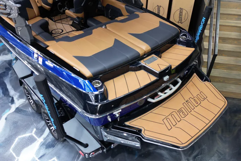 Slide: The Image of 2021 Malibu Wakesetter 20 VTX boat with tan and black interior, rear view. - 16