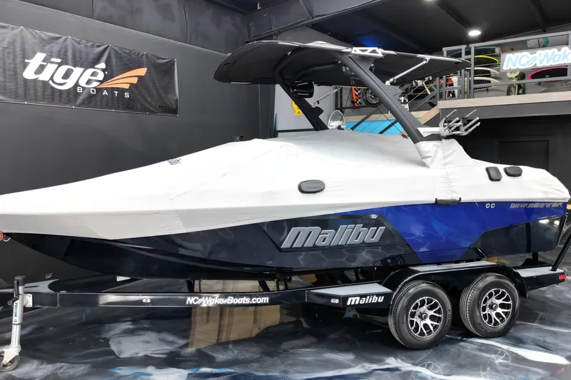 Slide: The Image of 2021 Malibu Wakesetter 20 VTX boat covered on trailer in showroom. - 20